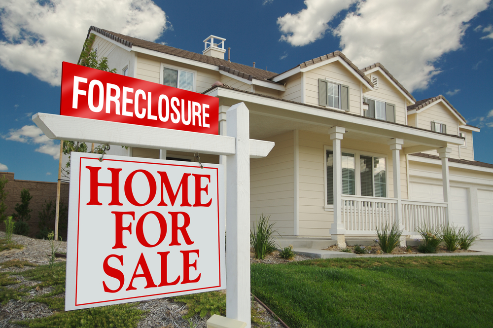 A home with a foreclosure sign.