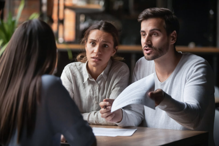 A person researching How to Avoid Scams When Seeking Debt Relief